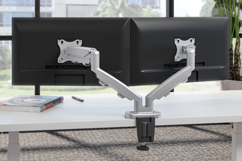 Image of a dual monitor arm attached to a desk